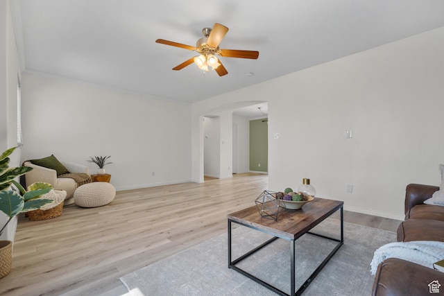 10574 N Sage Vista Ln, Cedar Hills, UT 84062 - living area with arched walkways, a ceiling fan, and light wood finished floors