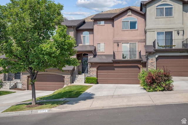 10574 N Sage Vista Ln, Cedar Hills, UT 84062 - townhome / multi-family property with stucco siding, stone siding, driveway, and a garage
