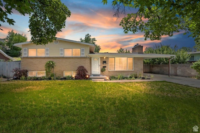 2268 E 7160 S, Cottonwood Heights, UT 84121 - split level home with a chimney, driveway, an attached carport, and brick siding