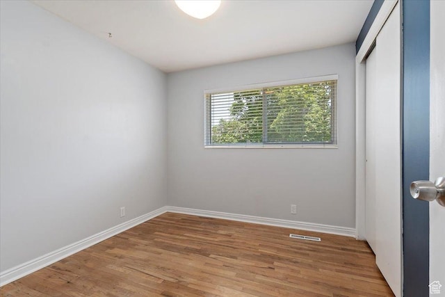 2268 E 7160 S, Cottonwood Heights, UT 84121 - unfurnished bedroom with light wood finished floors and a closet