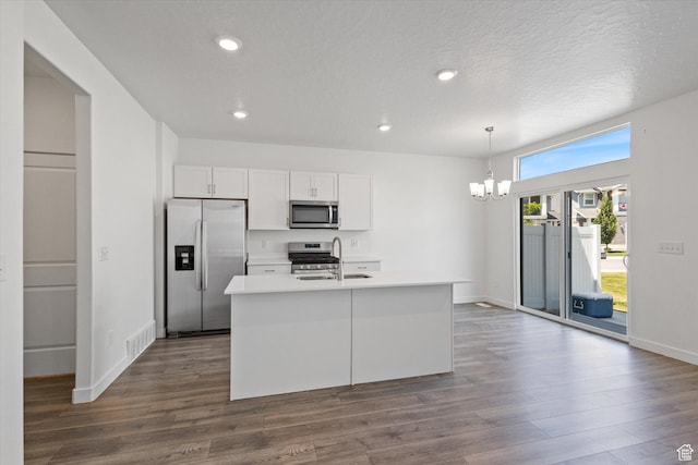 312 N 440 W, Pleasant Grove, UT 84062 - kitchen with stainless steel appliances, a chandelier, white cabinets, dark wood-type flooring, and a center island with sink