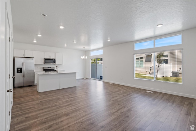 312 N 440 W, Pleasant Grove, UT 84062 - kitchen featuring appliances with stainless steel finishes, recessed lighting, open floor plan, dark wood-type flooring, and an island with sink