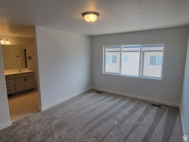 6846 S Static Peak Dr Unit 262, West Jordan, UT 84081 - spare room featuring light carpet and baseboards