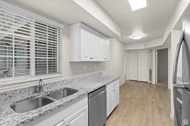 650 S Main St Unit 7105, Bountiful, UT 84010 - kitchen with appliances with stainless steel finishes, light wood-style flooring, white cabinetry, and light stone counters