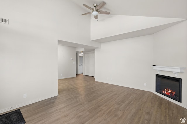 650 S Main St Unit 7105, Bountiful, UT 84010 - unfurnished living room with a glass covered fireplace, wood finished floors, a ceiling fan, and high vaulted ceiling