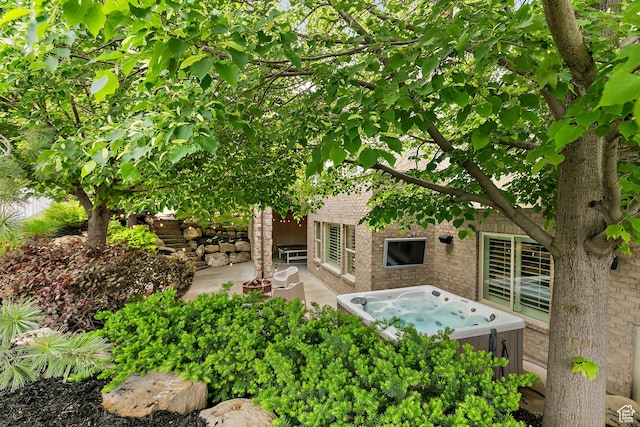 1095 N 700 W, American Fork, UT 84003 - rear view of property with a hot tub, a patio area, and brick siding