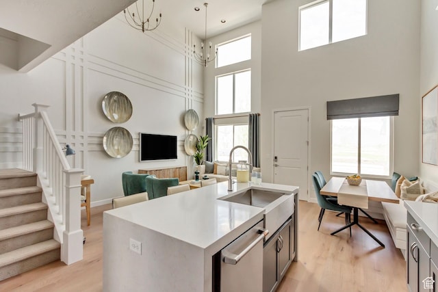 773 W 540 S Unit 344, American Fork, UT 84003 - kitchen featuring stainless steel dishwasher, a high ceiling, light wood-style floors, open floor plan, and light countertops