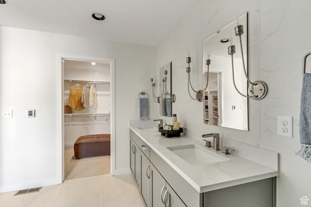 773 W 540 S Unit 344, American Fork, UT 84003 - bathroom featuring double vanity, marble look tiles, and a spacious closet