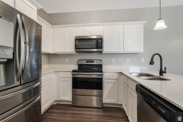 13073 S Newbridge Ln Unit E301, Herriman, UT 84096 - kitchen featuring stainless steel appliances, white cabinets, dark wood finished floors, decorative light fixtures, and light stone counters