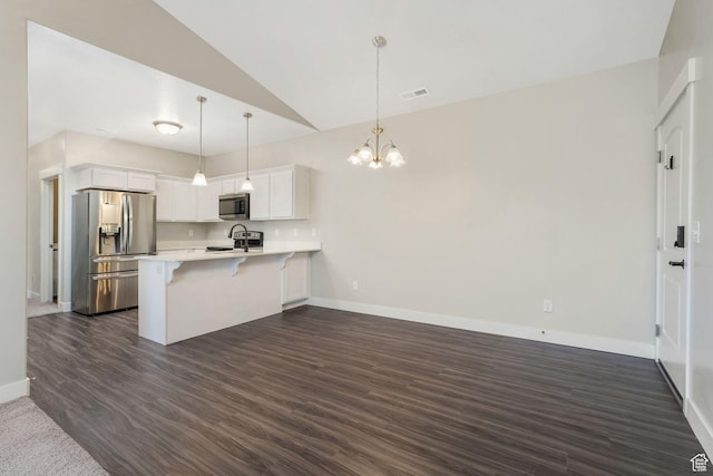 13073 S Newbridge Ln Unit E301, Herriman, UT 84096 - kitchen featuring stainless steel appliances, a peninsula, vaulted ceiling, light countertops, and a chandelier