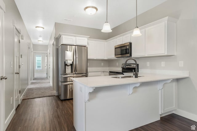 13073 S Newbridge Ln Unit E301, Herriman, UT 84096 - kitchen with stainless steel appliances, a peninsula, dark wood finished floors, and white cabinetry