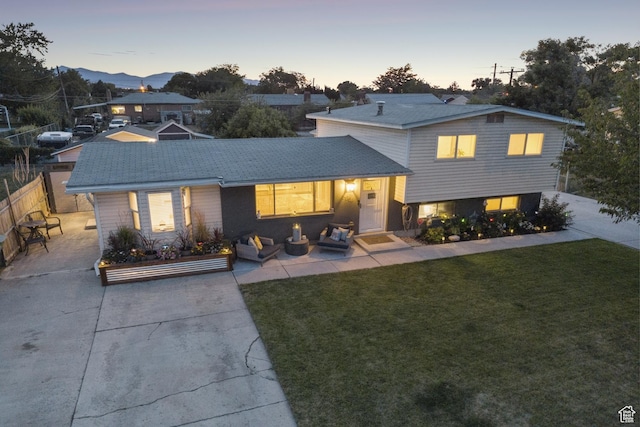 5964 S 610 W, Murray, UT 84123 - back of property at dusk with outdoor lounge area, driveway, and a mountain view