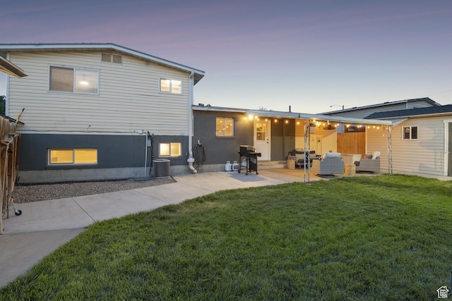 5964 S 610 W, Murray, UT 84123 - back of property at dusk with a lawn, a patio area, and an outdoor hangout area