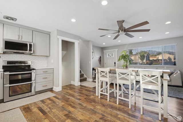 5964 S 610 W, Murray, UT 84123 - kitchen featuring appliances with stainless steel finishes, ceiling fan, backsplash, dark wood-style flooring, and gray cabinetry