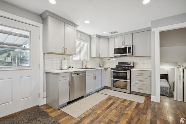5964 S 610 W, Murray, UT 84123 - kitchen featuring appliances with stainless steel finishes, gray cabinets, hardwood / wood-style floors, light countertops, and recessed lighting