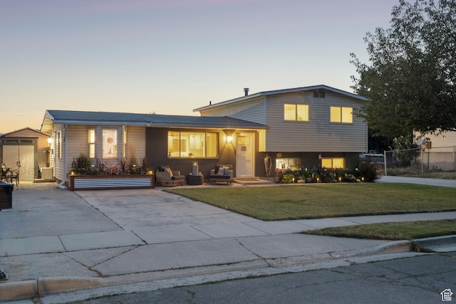5964 S 610 W, Murray, UT 84123 - tri-level home featuring a front yard, a shed, and driveway