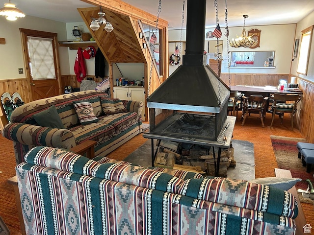 468 E Trail Rd, Brian Head, UT 84719 - living room with wainscoting, a wood stove, wood walls, and a chandelier
