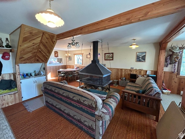 468 E Trail Rd, Brian Head, UT 84719 - carpeted living room featuring wainscoting, wooden walls, a chandelier, and a wood stove