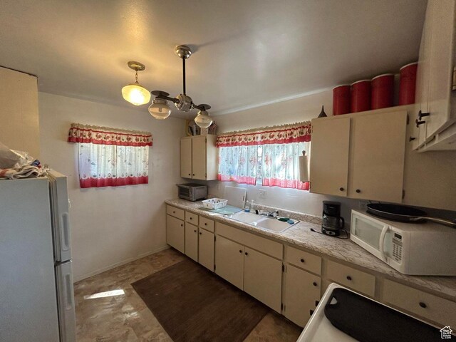 468 E Trail Rd, Brian Head, UT 84719 - kitchen featuring white appliances, light countertops, white cabinetry, and pendant lighting