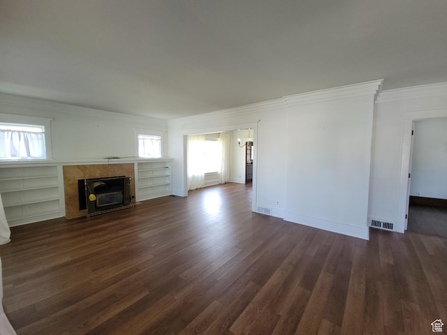 175 N 100 E, Price, UT 84501 - unfurnished living room with crown molding, healthy amount of natural light, dark wood-type flooring, a high end fireplace, and a chandelier