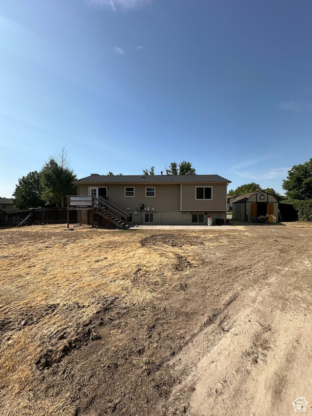 3836 W Jacquelyn St S, West Jordan, UT 84088 - back of property with a shed and stairway