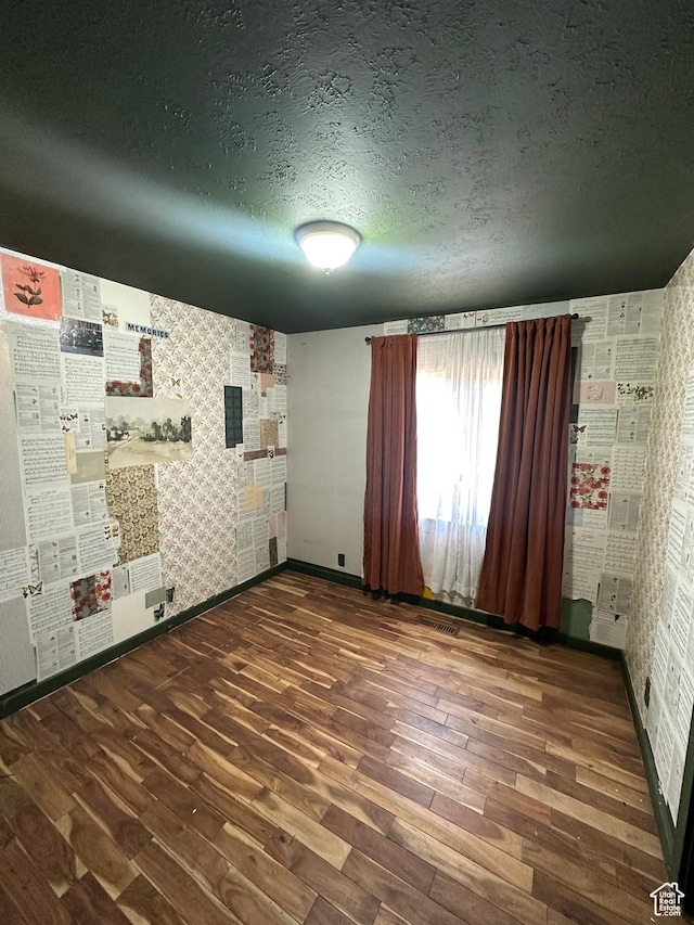 3836 W Jacquelyn St S, West Jordan, UT 84088 - unfurnished room featuring wood finished floors, a textured ceiling, and wallpapered walls