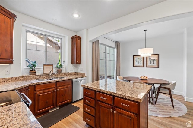 10787 N Town Center Pkwy, Highland, UT 84003 - kitchen featuring stainless steel dishwasher, light wood-type flooring, pendant lighting, arched walkways, and a center island