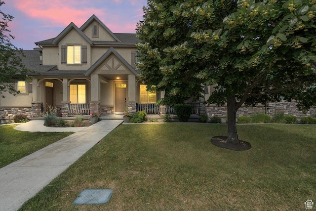 10787 N Town Center Pkwy, Highland, UT 84003 - view of front of house with stucco siding, a porch, stone siding, and a lawn