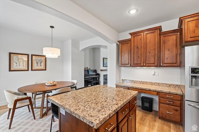 10787 N Town Center Pkwy, Highland, UT 84003 - kitchen with stainless steel fridge with ice dispenser, arched walkways, light wood-style flooring, a kitchen island, and recessed lighting