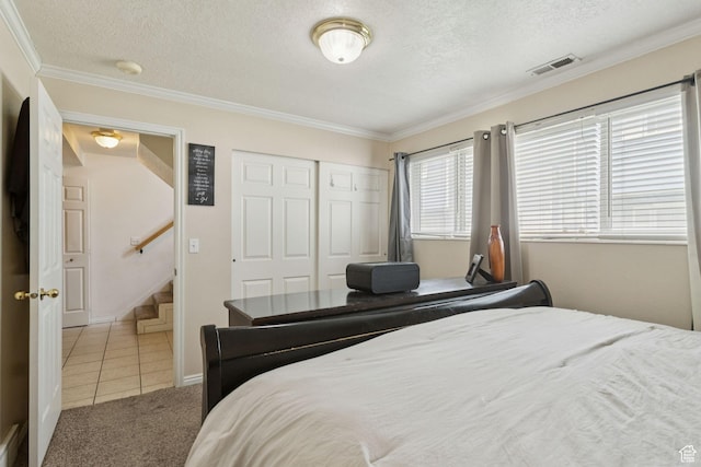 248 E Winslow Ave S Unit 3-C, South Salt Lake, UT 84115 - carpeted bedroom featuring ornamental molding, tile patterned flooring, a textured ceiling, and a closet