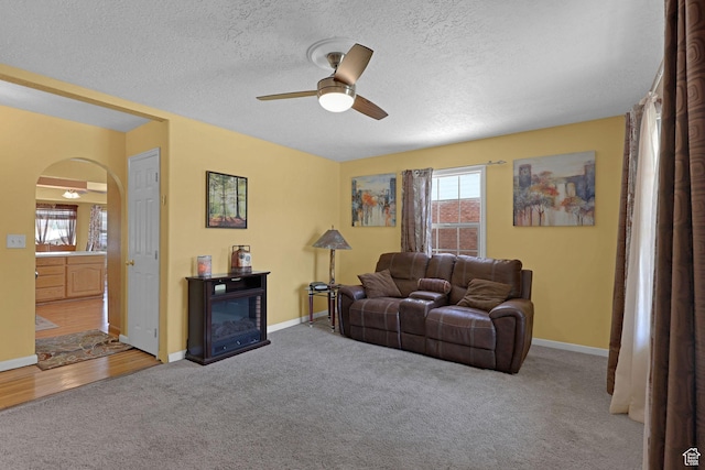 522 E Diana St, South Ogden, UT 84403 - living area with arched walkways, a ceiling fan, carpet flooring, and a textured ceiling