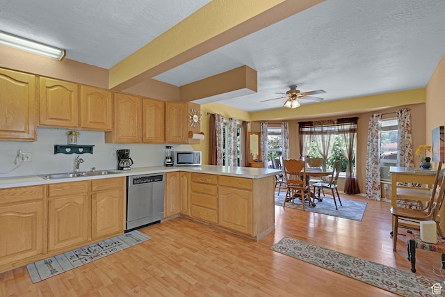 522 E Diana St, South Ogden, UT 84403 - kitchen with appliances with stainless steel finishes, light wood-style flooring, light countertops, a peninsula, and a textured ceiling