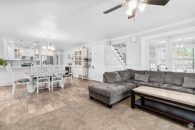360 S 300 E, Ephraim, UT 84627 - living area with ornamental molding, ceiling fan, stairs, a chandelier, and light wood-style floors