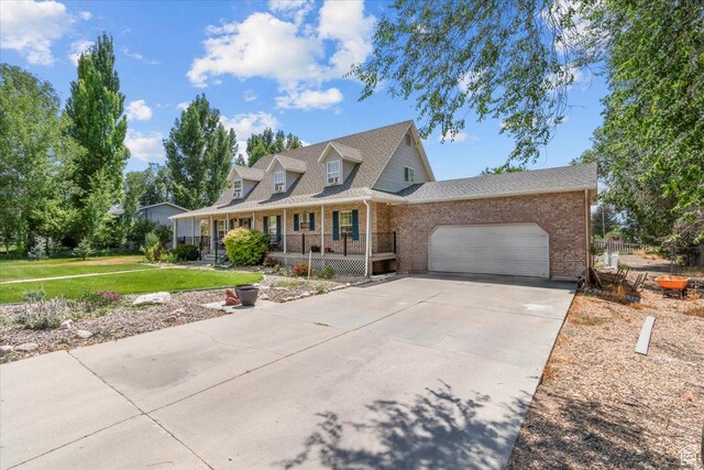 360 S 300 E, Ephraim, UT 84627 - view of front facade featuring brick siding, covered porch, a garage, a front yard, and driveway