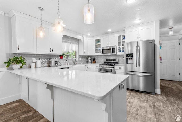 360 S 300 E, Ephraim, UT 84627 - kitchen featuring appliances with stainless steel finishes, a peninsula, glass insert cabinets, white cabinets, and recessed lighting