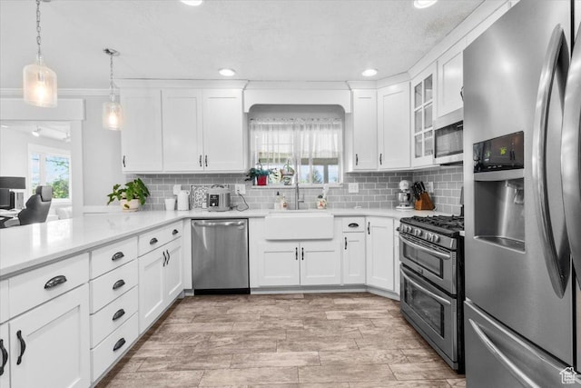 360 S 300 E, Ephraim, UT 84627 - kitchen with appliances with stainless steel finishes, backsplash, light countertops, white cabinets, and recessed lighting