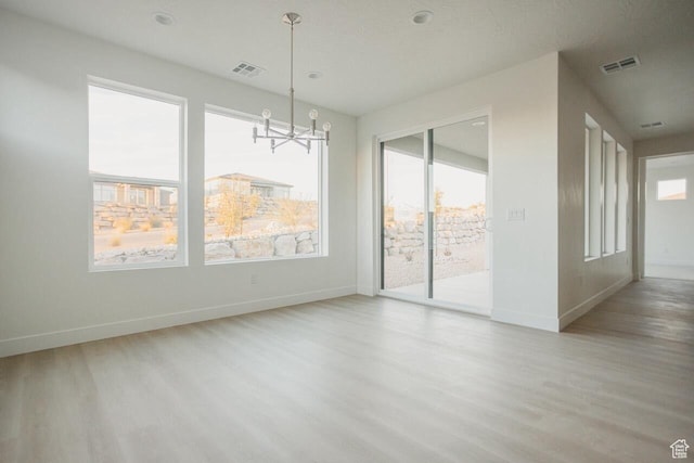 43 Rosalia Rdg, St George, UT 84770 - empty room with wood finished floors, plenty of natural light, and a chandelier
