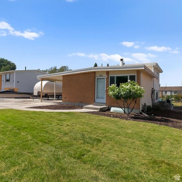 4954 W Elaine Dr S, West Valley City, UT 84120 - view of front of home with a front yard, an attached carport, entry steps, and driveway