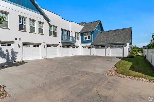 11184 S Waltana Way Unit 205, South Jordan, UT 84095 - view of property exterior with driveway, a residential view, an attached garage, and stucco siding