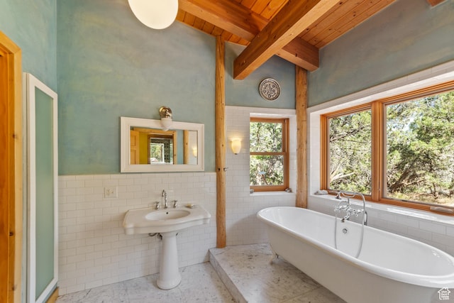 338 Taylor Ln, Castle Valley, UT 84532 - bathroom with a wood ceiling with exposed beams, tile walls, wainscoting, and a soaking tub