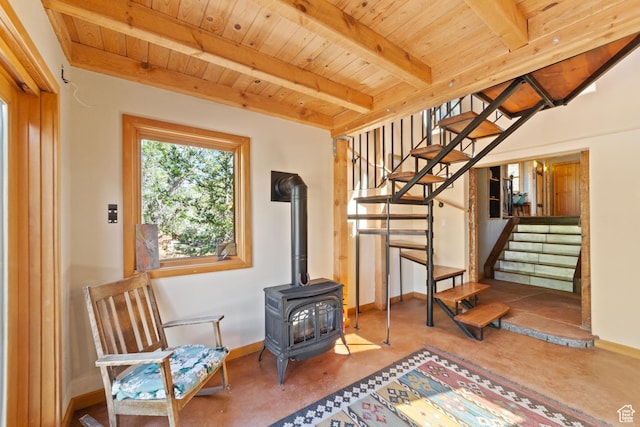 338 Taylor Ln, Castle Valley, UT 84532 - unfurnished room with a wooden ceiling with exposed beams, stairway, a wood stove, and finished concrete flooring