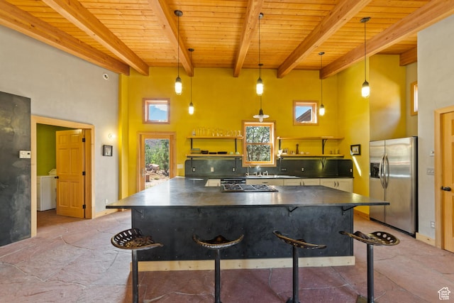 338 Taylor Ln, Castle Valley, UT 84532 - kitchen featuring appliances with stainless steel finishes, dark countertops, a wood ceiling with exposed beams, stone tile floors, and open shelves