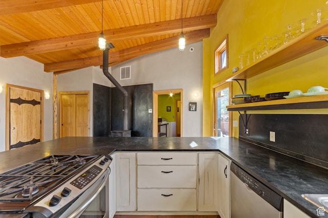338 Taylor Ln, Castle Valley, UT 84532 - kitchen with appliances with stainless steel finishes, a wooden ceiling with exposed beams, white cabinets, dark countertops, and a wood stove