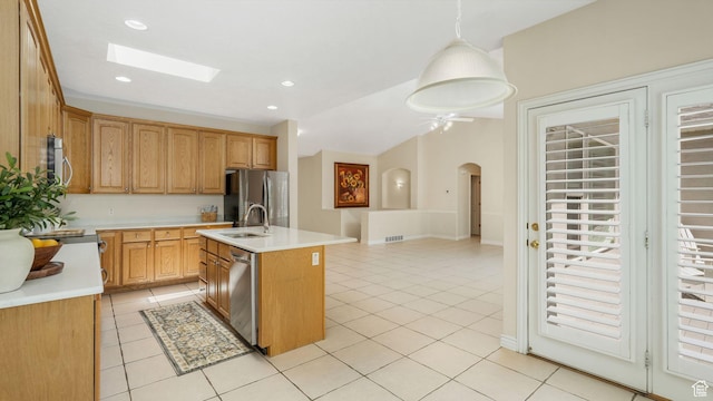 1257 W Bateman Ponds Way S, West Jordan, UT 84084 - kitchen with appliances with stainless steel finishes, light countertops, a kitchen island with sink, light tile patterned flooring, and recessed lighting