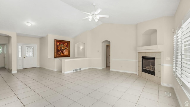 1257 W Bateman Ponds Way S, West Jordan, UT 84084 - unfurnished living room featuring ceiling fan, lofted ceiling, a fireplace, arched walkways, and light tile patterned floors