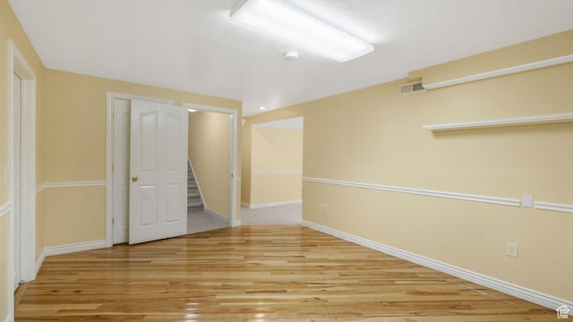 1257 W Bateman Ponds Way S, West Jordan, UT 84084 - spare room with wood finished floors, a smoke detector, and stairs