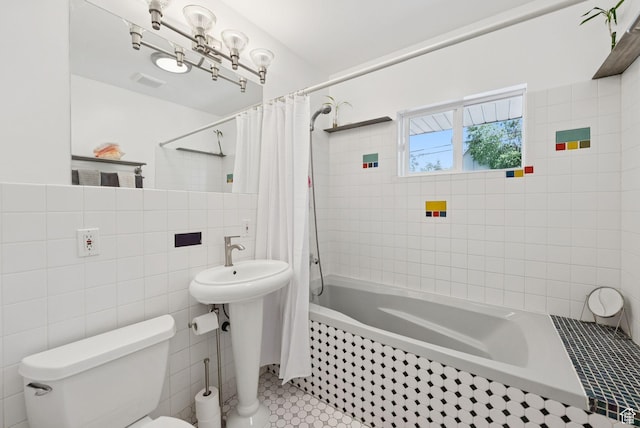 1527 E Emerson Ave S, Salt Lake City, UT 84105 - bathroom with tile walls, tiled shower / bath combo, and tile patterned floors