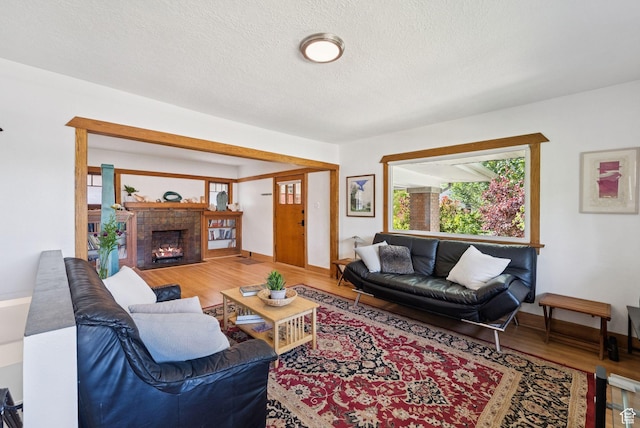1527 E Emerson Ave S, Salt Lake City, UT 84105 - living area featuring wood finished floors, a textured ceiling, and a fireplace with flush hearth