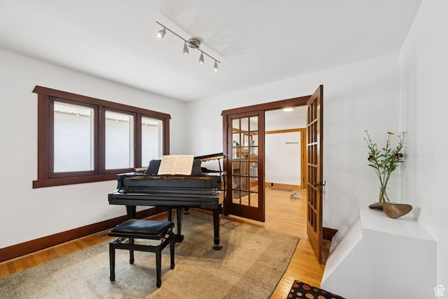 1527 E Emerson Ave S, Salt Lake City, UT 84105 - living area with french doors, light wood-style flooring, and track lighting