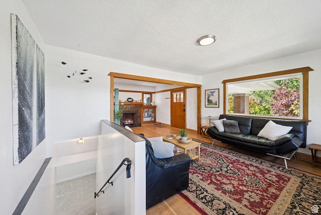 1527 E Emerson Ave S, Salt Lake City, UT 84105 - living area with a fireplace, a textured ceiling, and light wood-style floors